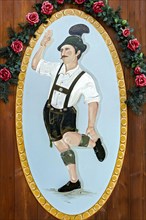 Man dancing the Schuhplattler in Bavarian dress