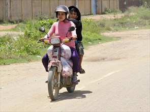 Two women riding a moped