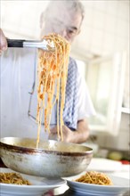 Chef dishing up spaghetti