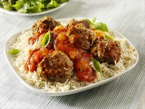 Meat balls with a ragu sauce on rice