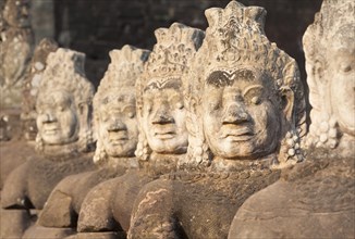Asura statues aligned at the south gate causeway of Angkor Thom