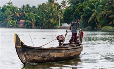 Indian man steering a boat