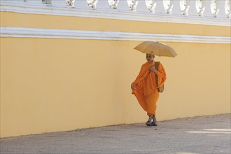 Buddhist monk walking along the walls of the Royal Palace