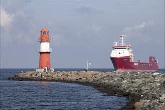 Lighthouse and a cargo ship