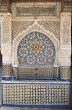 Traditional water fountain with mosaics and stucco work