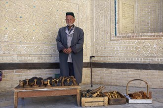 Local man with bread stamps in front of the Kalon Mosque