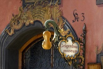 Wrought iron hanging shop sign of the Geigenbaumuseum violin making museum