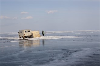 Fishermen fishing on the frozen Lake Baikal
