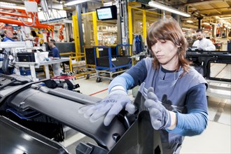 Female employee during the assembly of a leadframe