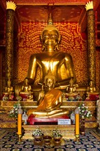 Golden Buddha statues in the Viharn of Wat Doi Ngam Muang