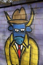 Ox figure wearing a tie and a hat