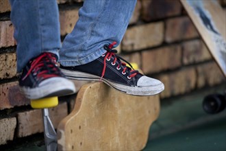 Teenager's feet on longboard
