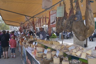 Market stall selling sausages and cheeses