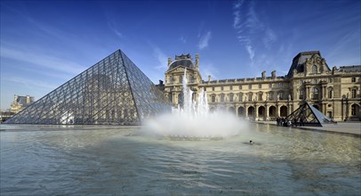 Fountains in front of the entrance pyramid of the Louvre Museum designed by architect IM Pei