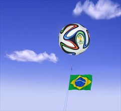 World Cup football as a tethered balloon against a blue sky with the flag of Brazil flying