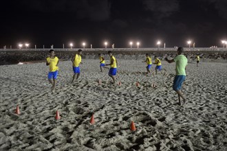 Brazilian youngsters training at night on the beach for the Street Children World Cup 2014