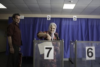 Elderly woman at the ballot box