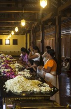 Believers praying in the Temple of the Sacred Tooth Relic