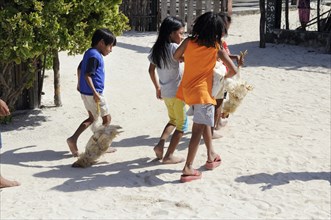 Kuna Indian children carrying chickens