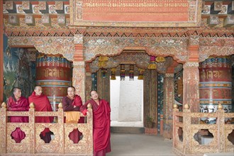 Four monks in red robes