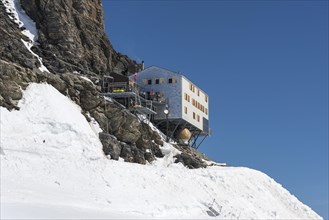 Monchsjoch Hut on a rock wall