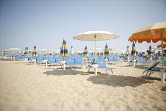 Empty beach with parasols and sun beds