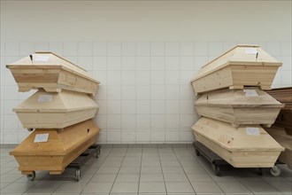 Coffins containing dead bodies are stacked up in a crematorium ready for cremation