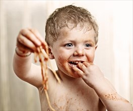 Toddler eating Spaghetti