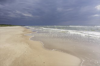 Sandy beach on the Baltic sea with storm clouds