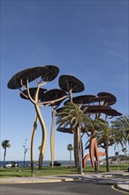 Large pine tree sculpture on the promenade of La Pineda