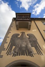 Adler fresco under a bay window on a house facade