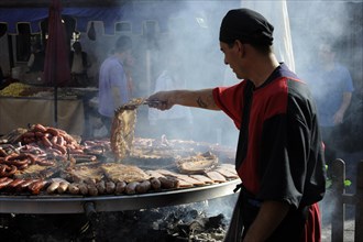 Cook handles giant barbecue at the annual All Saints Market in Cocentaina