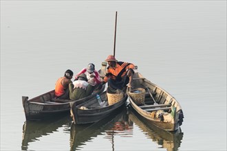Fishermen in their boats in the morning light