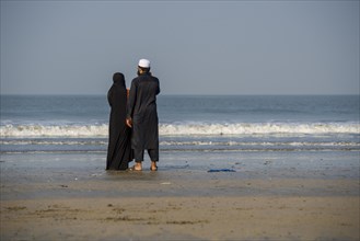 A Muslim couple is standing at Juhu Beach