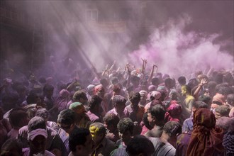 Devotees celebrating and throwing coloured powder