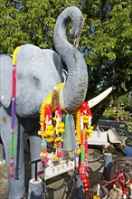 Statue of an elephant decorated with flowers