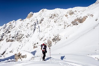 Ski tourers ascending to the Col di Poma in Villnoss valley