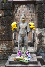 Buddhist statue of Bodhisattva Avalokiteshvara with offerings in the temple