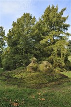 Stone statues overgrown with moss
