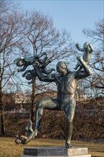 Bronze sculpture of a father wrestling with four children