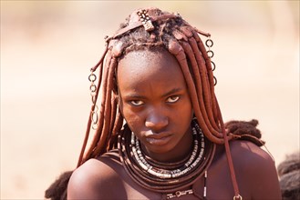 Portrait of a young Himba with traditional headdress for pregnant women