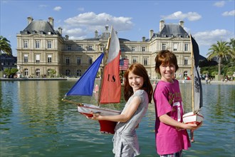 Children playing with ships at the pond of the Palais du Luxembourg