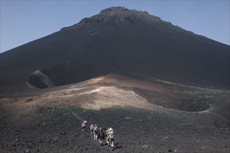 Hikers in the volcanic landscapes of the volcano Pico do Fogo
