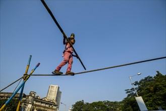 A little girl is balancing on a rope