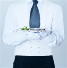 Waiter holding a silver tray