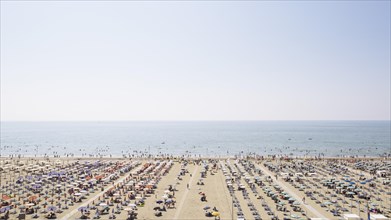 View of a beach with sunshades and sun beds in the morning