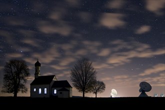 St. Johann Chapel and the satellite earth station in front of the night sky