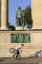 BMX cyclist in front of the Millennium Monument in Heroes' Square