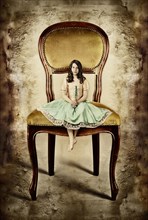 Girl siting on an oversized antique chair