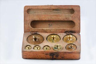 Old brass weights in wooden box with lid
